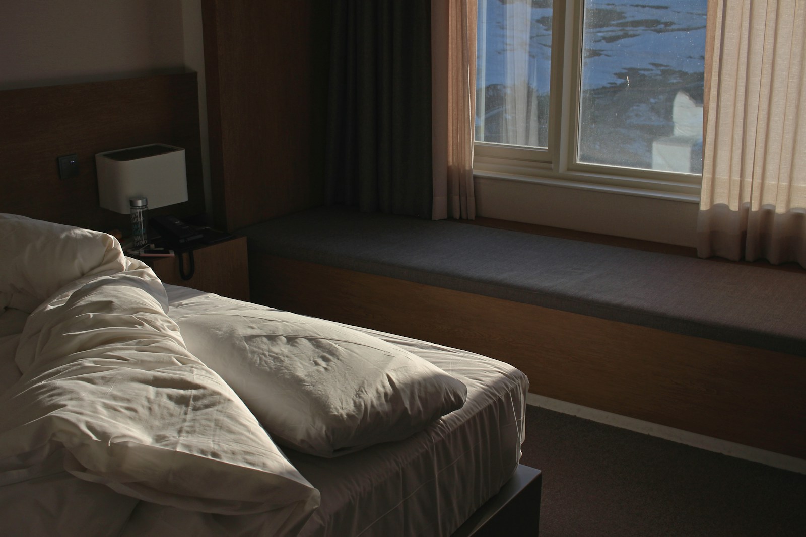 A bright hotel room with soft natural window light